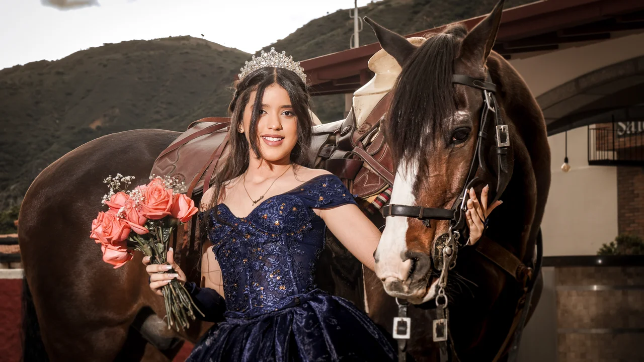 Quinceañera junto a un caballo con ramo